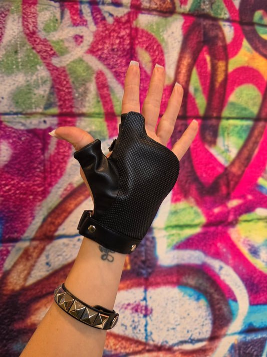 Hand wearing a black disability glove with a colorful graffiti background