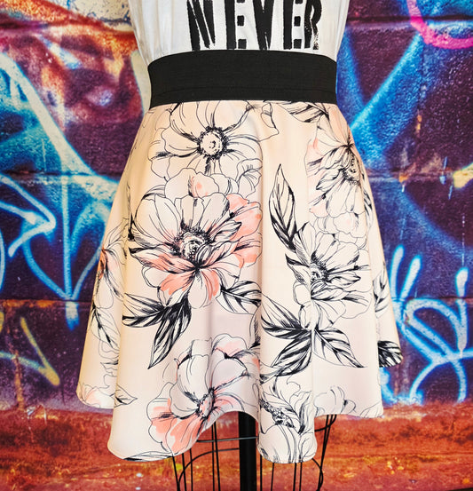 Skirt with floral pattern on a mannequin against a graffiti-covered wall.