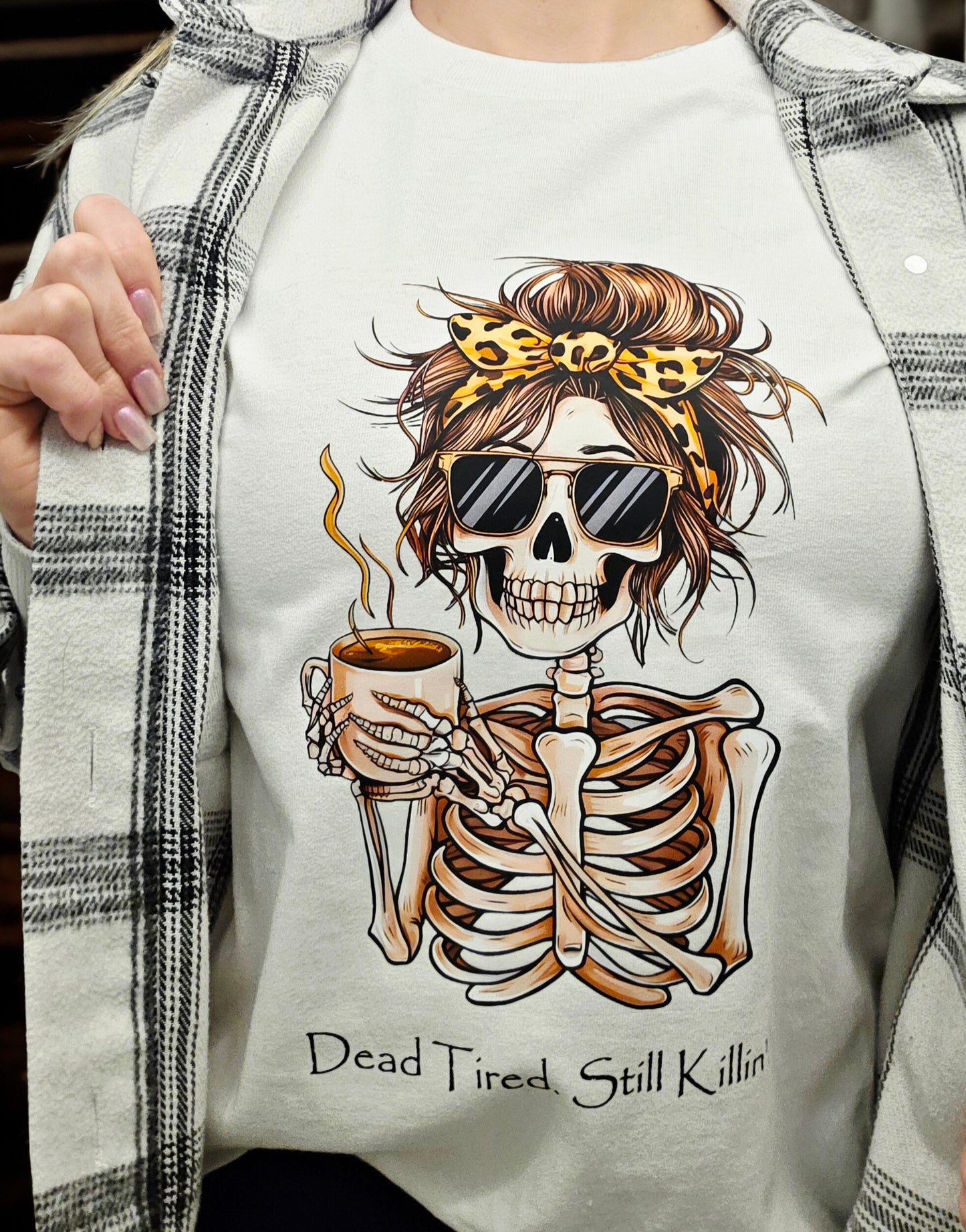 T-shirt with graphic of skeleton holding coffee