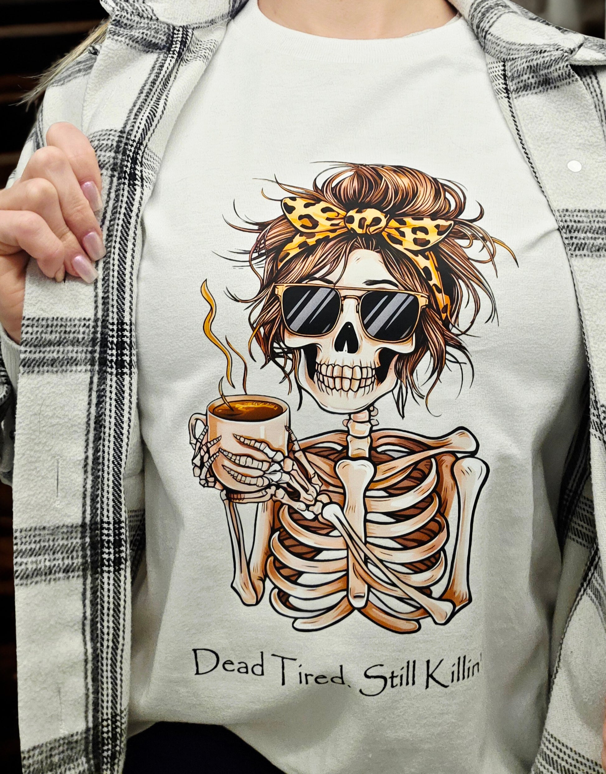 T-shirt with graphic of skeleton holding coffee