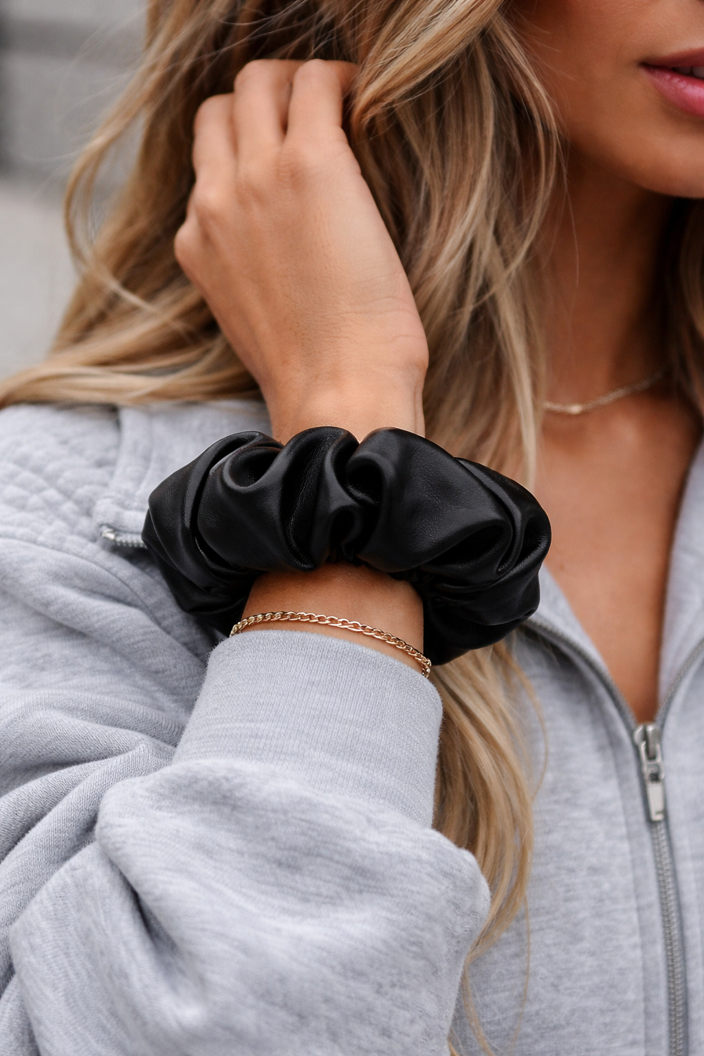 girl with faux leather scrunchie on wrist