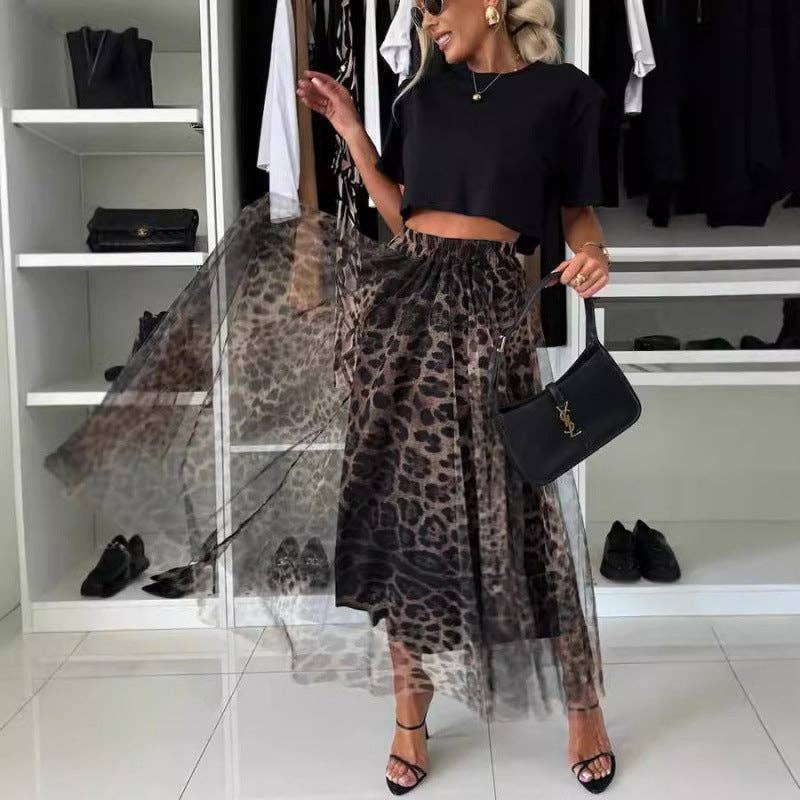Person wearing a black top and leopard print skirt in a clothing store.